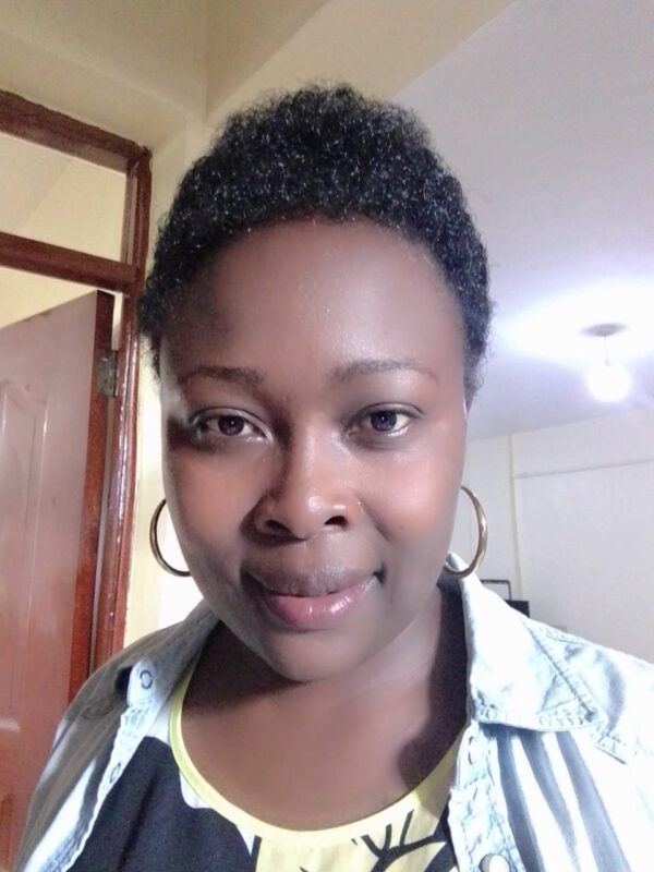 A woman in Homa Bay County wearing a black shirt and hoop earrings spreads hope amidst gender-based violence.