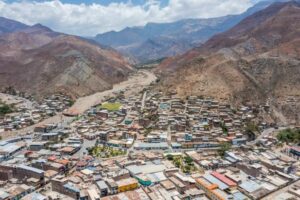An aerial view of a resilient town nestled in the mountains of Peru.