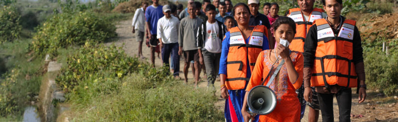 A test flood drill, in Nepal, showing the local community following flood trained members to safety.