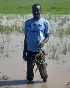 Simon Odhiambo stands in one of his flooded fields, also in Kisumu County