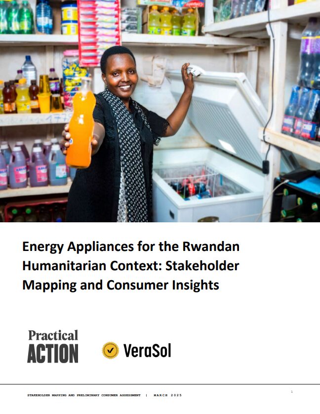 A woman in a shop holds up a bottle of orange liquid, standing in front of shelves stocked with assorted bottled drinks.