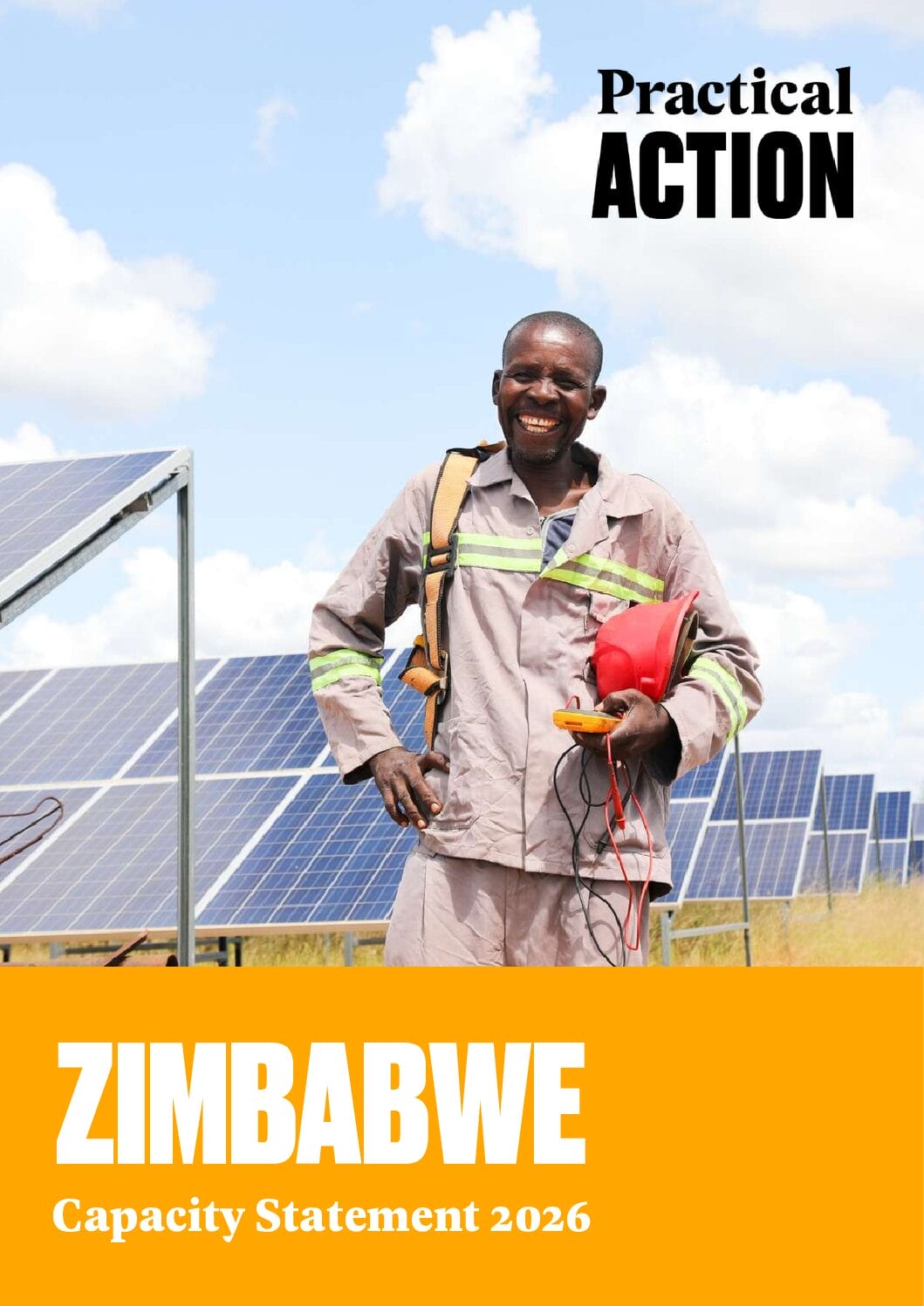 A smiling man in work clothes stands beside solar panels, holding a red helmet and equipment. The text reads: "Practical Action. ZIMBABWE Capacity Statement 2026." Blue sky with clouds is in the background.
