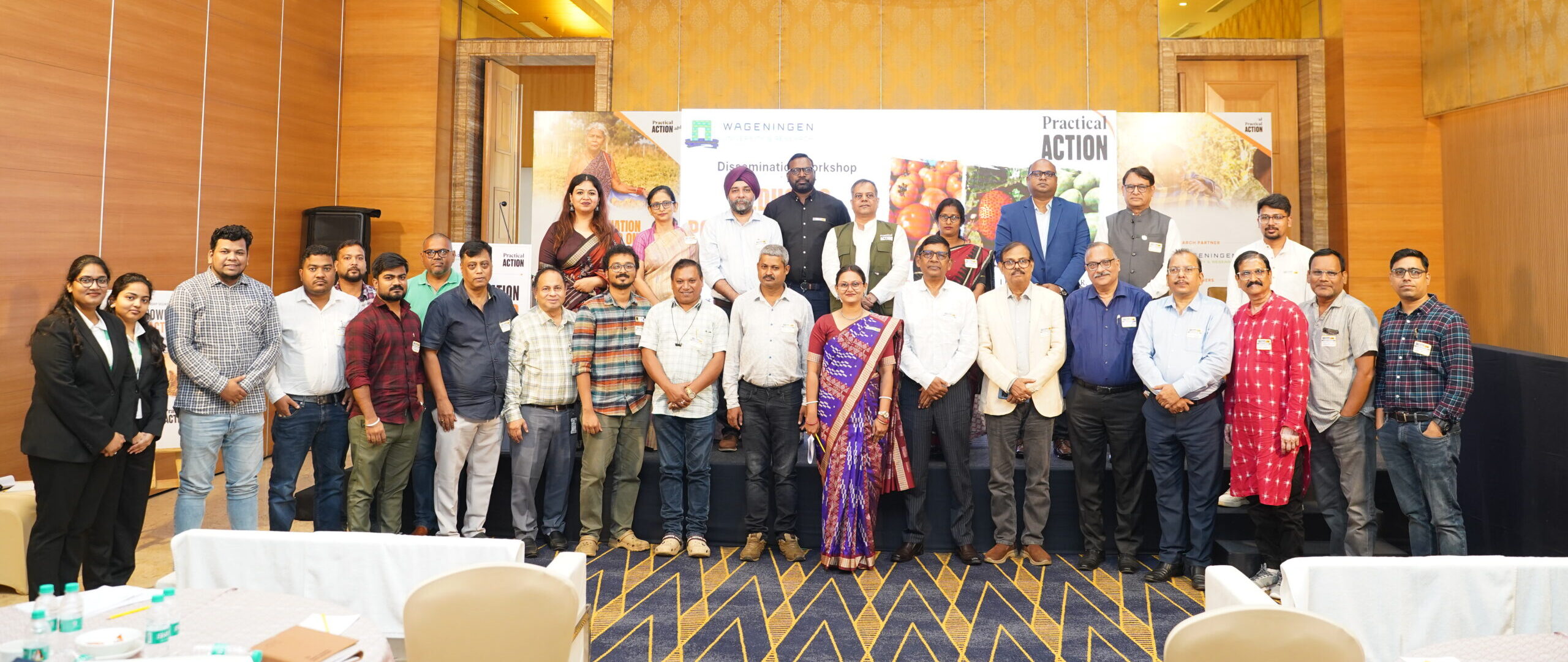 A large group of people posing for a photo in front of a workshop banner.